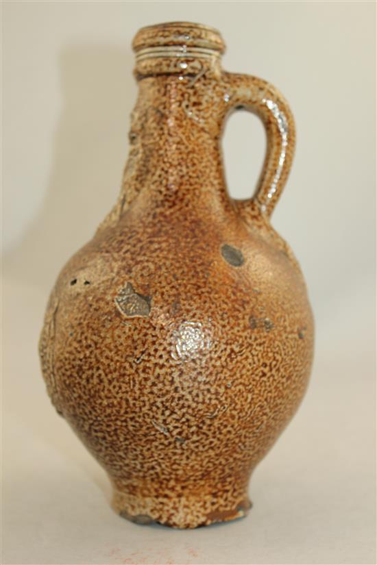 A German stoneware bellarmine jug, 16th / 17th century, 22cm.